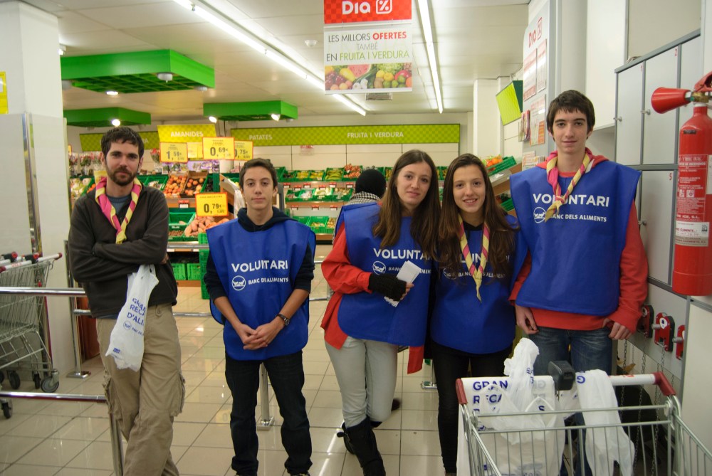 escoltes ajudant a recaptar menjar pel banc d'aliments